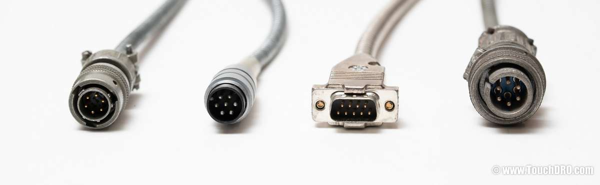 Anilam scale connector types side by side — 6-pin twist-lock (Bendix PT06), 7-pin threaded barrel, 9-pin D-Sub, and 6-pin threaded barrel (MIL-style)