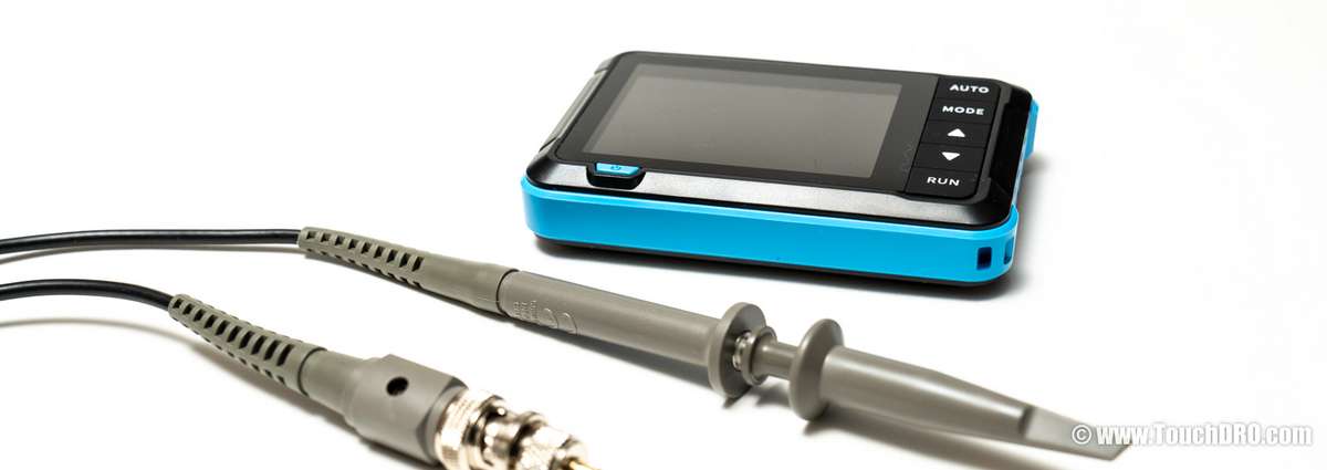Inexpensive handheld single-channel oscilloscope and probe, the kind used for DRO scale pinout reverse engineering