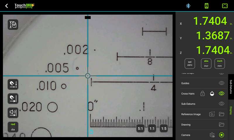 The live camera feed pointed at an inspection loupe reticle, with the 0.002 inch circle and fine scale graduations clearly visible