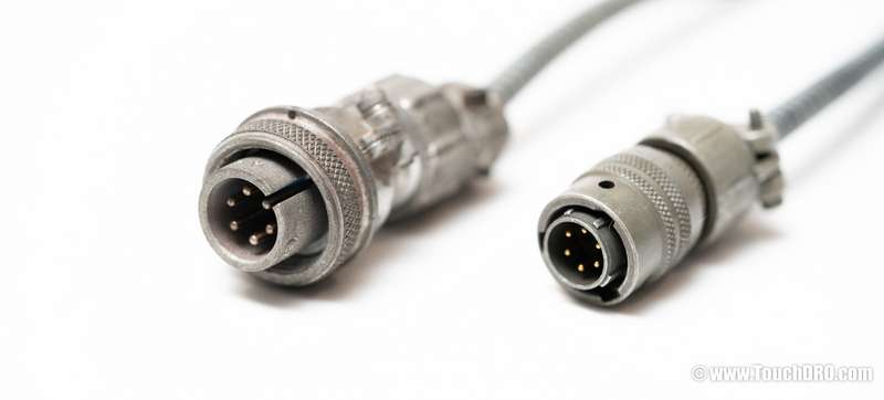 Anilam 6-pin threaded collar connector (left) next to the more common 6-pin twist-lock (Bendix PT06) connector on the right